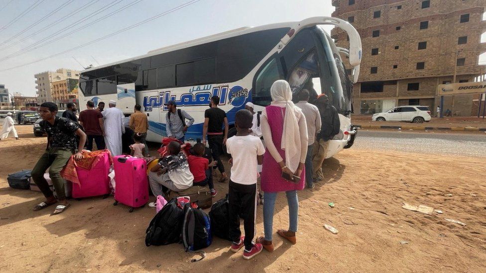 People gather as they flee clashes between the paramilitary RSF and the army in Khartoum