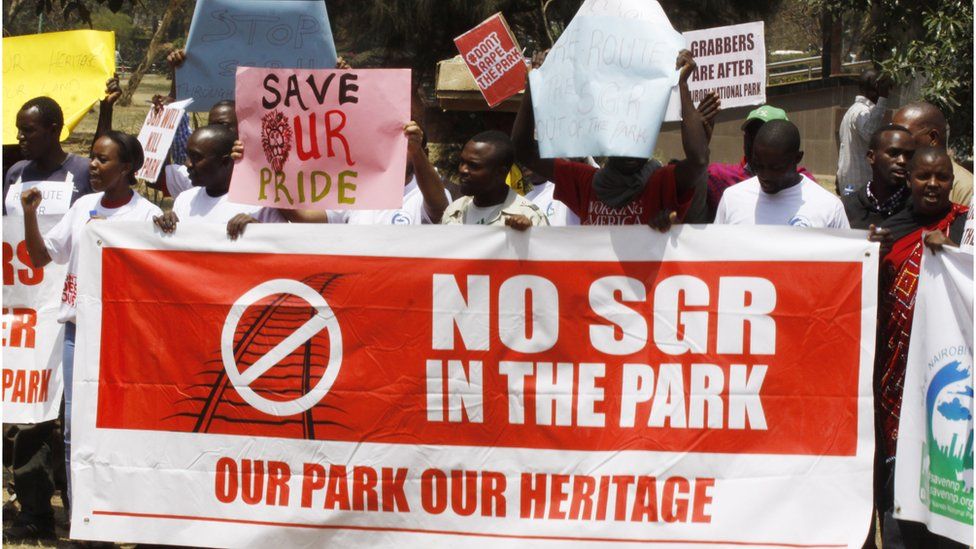 Kenyans hold up signs as they protest in solidarity to protect the Nairobi National Park in Nairobi, Kenya, Friday 23 September 2016