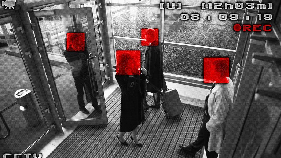 Camera's eye view of people walking through an office