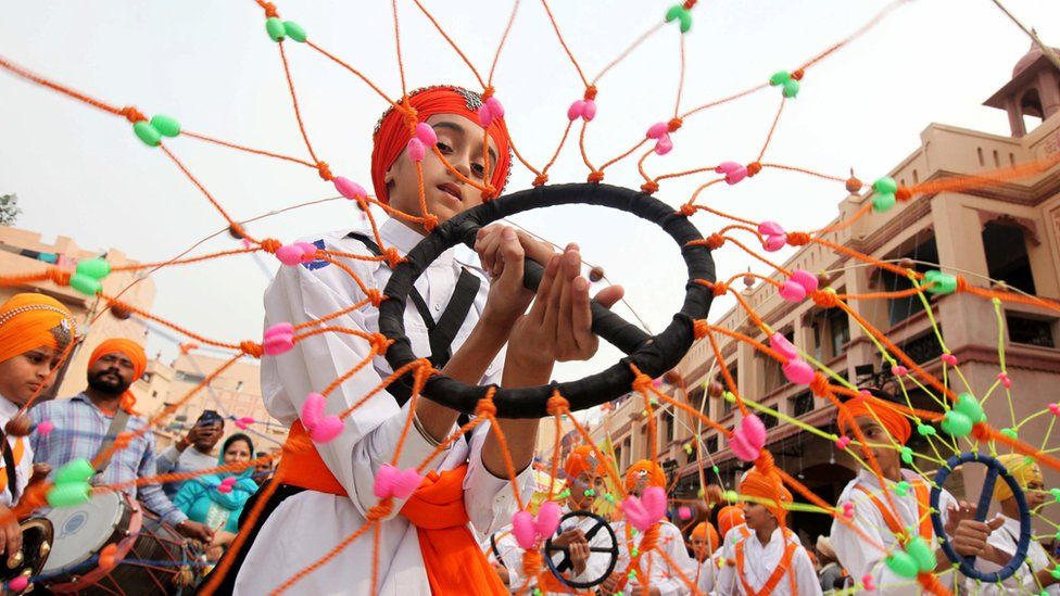 A Sikh boy performs Gatkha - a traditional form of martial arts during a religious procession