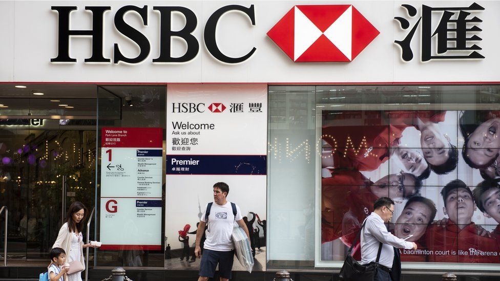 Pedestrians are seen walking past a branch of HSBC bank in Causeway Bay