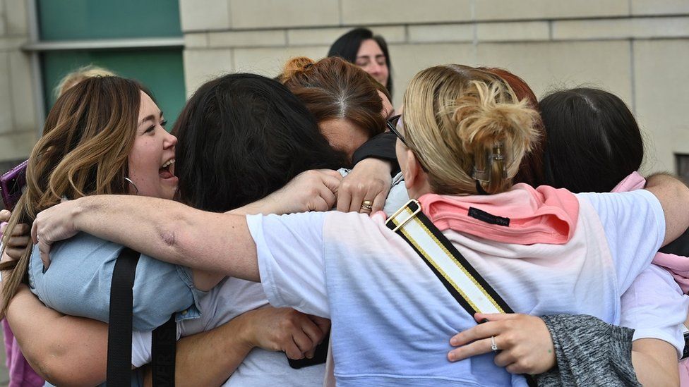 Jennifer Dornan's relatives embracing outside court
