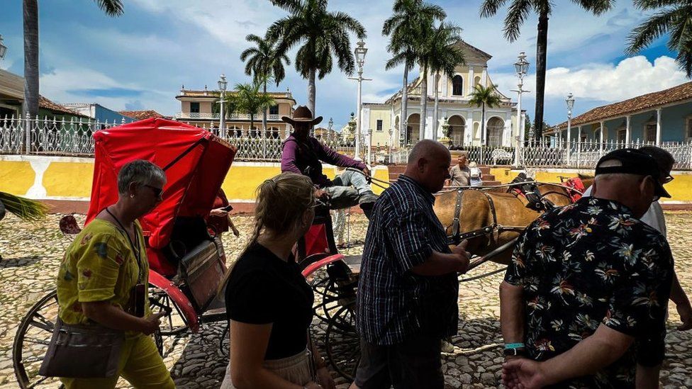 Tourists walk in a street in the town of Trinidad, Sancti Spiritus province, Cuba on 20 June 2023