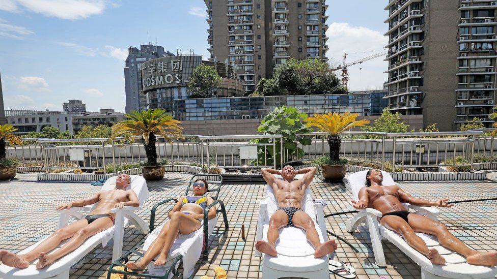 Bodybuilding enthusiasts enjoy sunbathing at Grand Metropark Hotel on July 20, 2022 in Hangzhou.