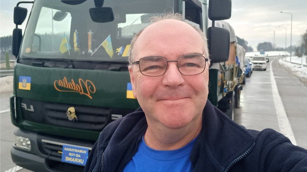 Steve Hodgson takes a picture in front of his truck