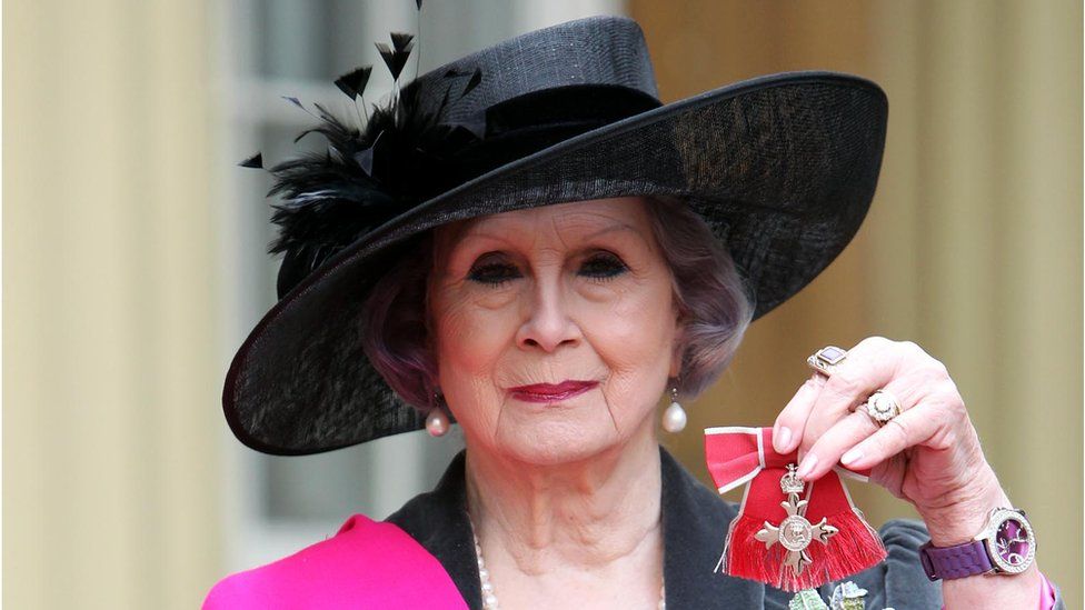 April Ashley with her MBE medal following an Investiture ceremony at Buckingham Palace in 2012
