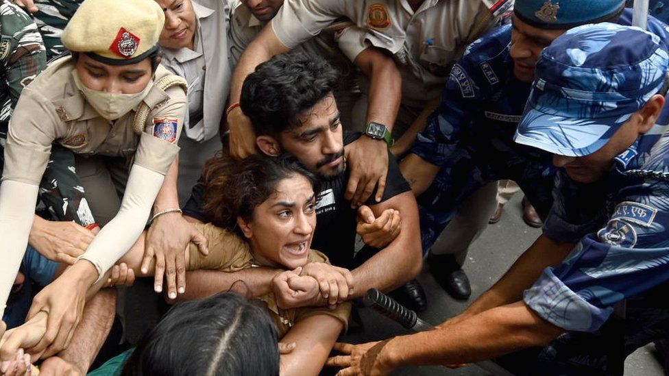 Security personnel arresting wrestler Vinesh Phogat