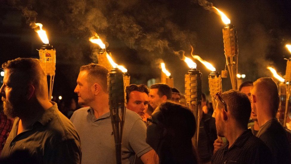 Picture from rally held in August show people marching carrying lit torches