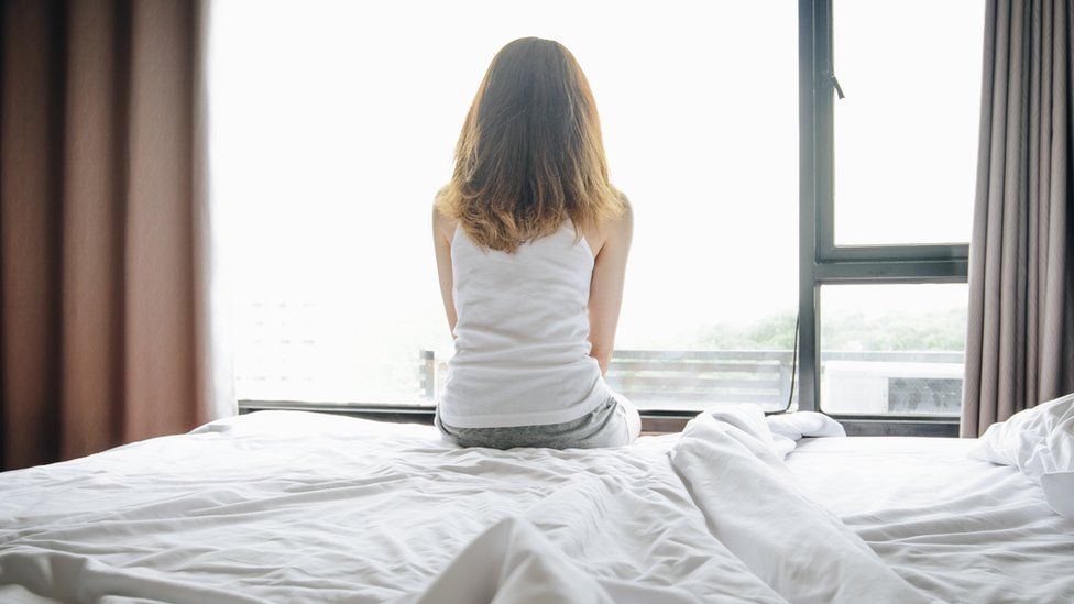 Stock image of woman on a bed