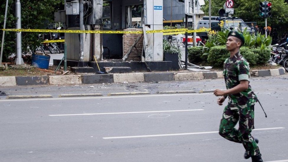 A soldier guard a blast site in Indonesia