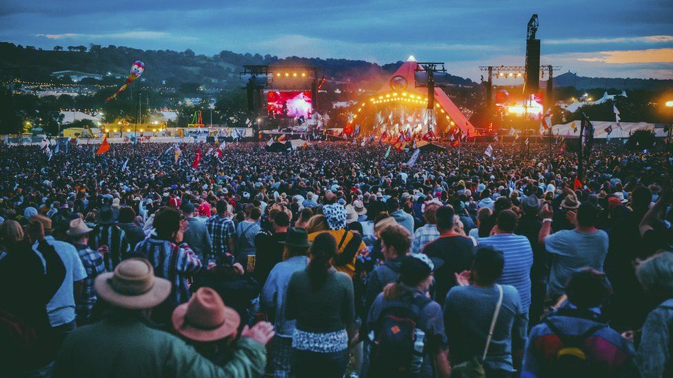 Crowds in front of the Pyramid stage at Glastonbury at night