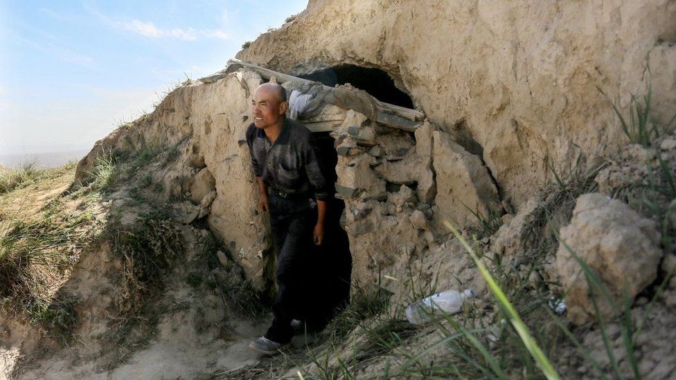 This photo taken on May 24, 2021 shows shepherd Zhu Keming, hailed as a hero in China for rescuing six ultramarathon runners when extreme weather hit the area leaving at least 20 dead, showing the cave dwelling where he sheltered the stricken athletes near the city of Baiyin, in China's northwestern Gansu province.