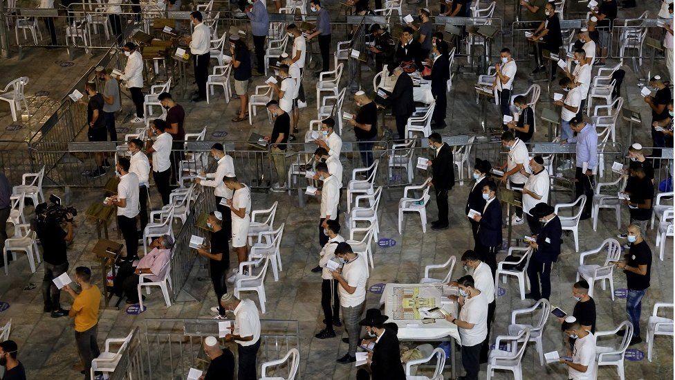 Religious Jews keep social distancing inside dividing cells while participating in the Slichot (forgiveness) prayer, the last prayer on the eve of Rosh Hashana, the Jewish New year, at the Western Wall in the old city of Jerusalem, on 18 September 2020.