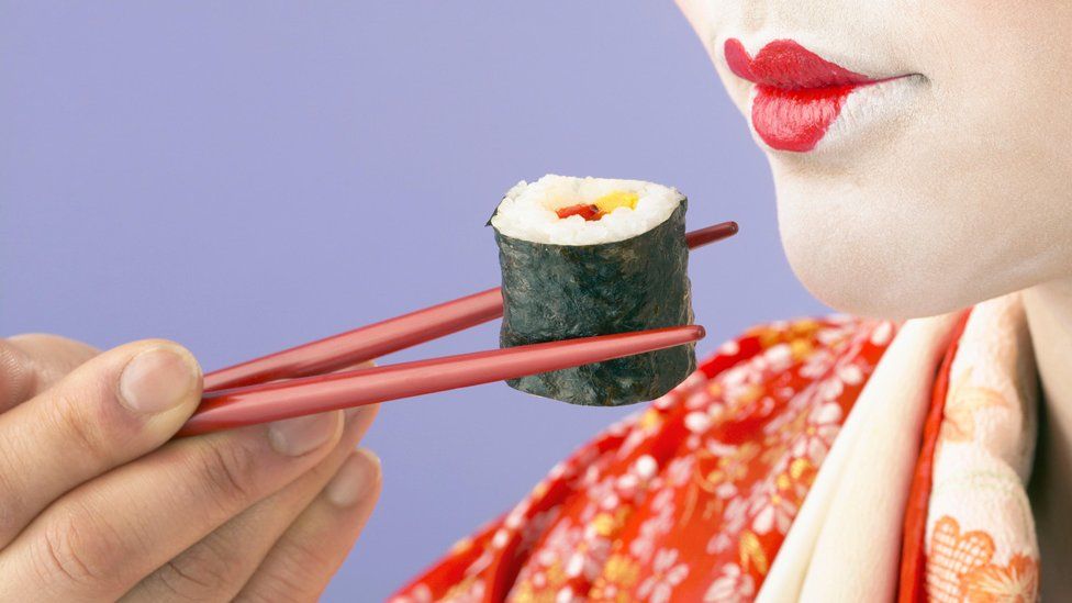 Geisha eats a sushi roll
