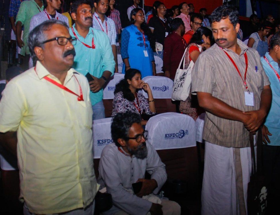Two delegates refusing to rise while playing the national anthem at the IFFK venue of Nishagandhi open air auditorium before the screening of Egyptian film Clash Monday evening