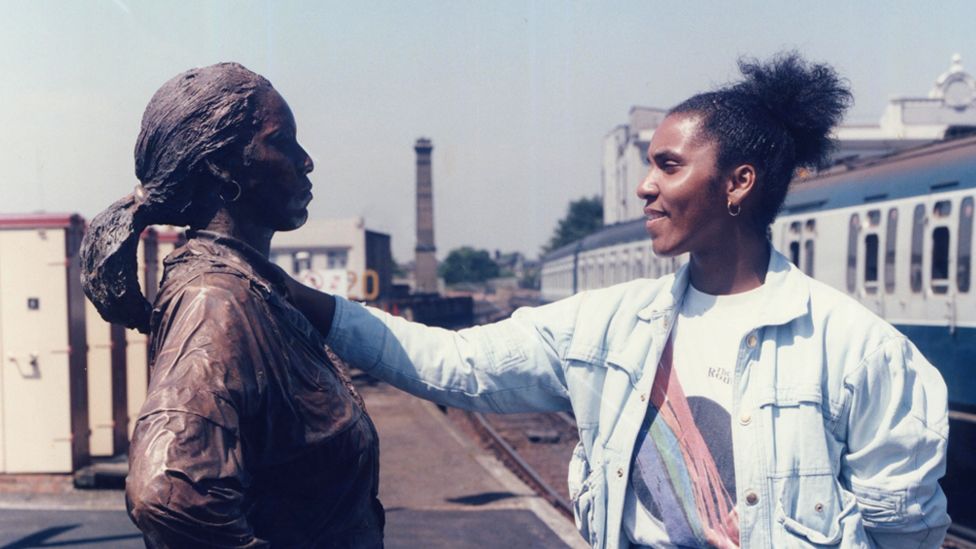 Joy Battick stands facing her original statue in 1986
