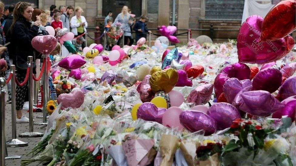 Balloons and flowers at a makeshift memorial at St Ann"s Square, Manchester