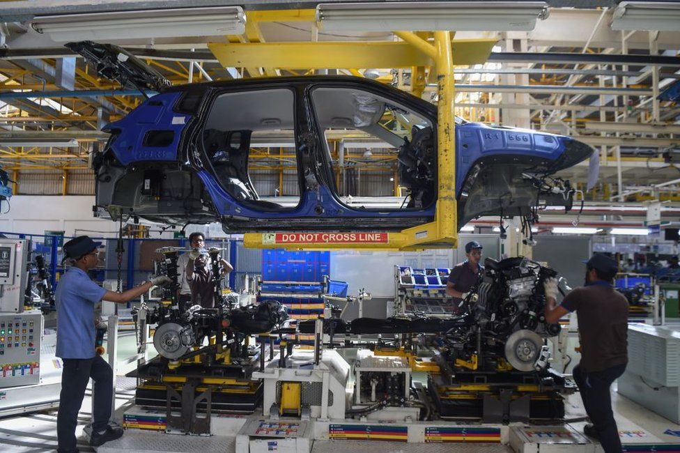 Workers assemble a car at a FCA India Automobiles manufacturing facility in Ranjangaon, some 200km east of Mumbai.