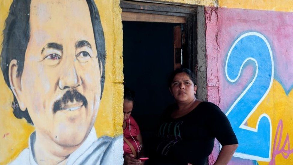 A woman sits next to an image of Nicaragua"s President Daniel Ortega in Catarina, Nicaragua October 1, 2020.REUTERS