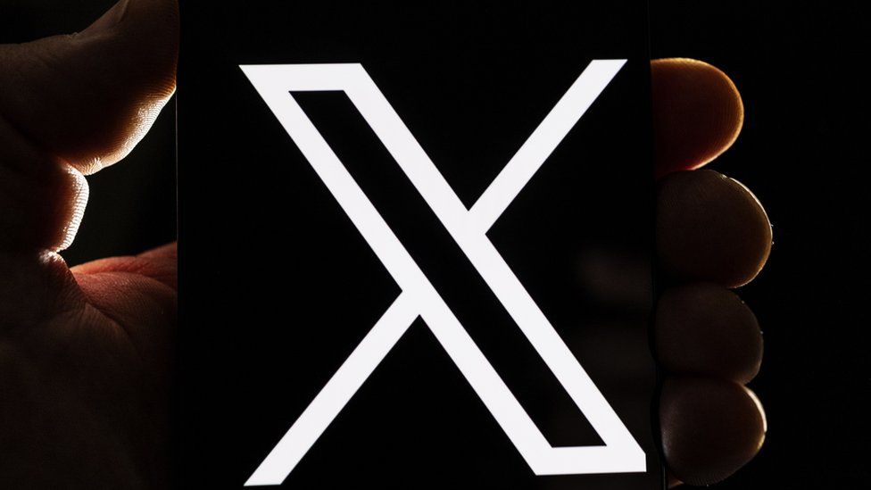 X's logo seen on a screen