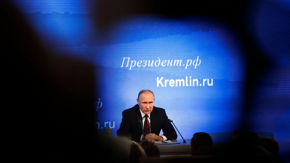 A picture of Vladimir Putin at a news conference