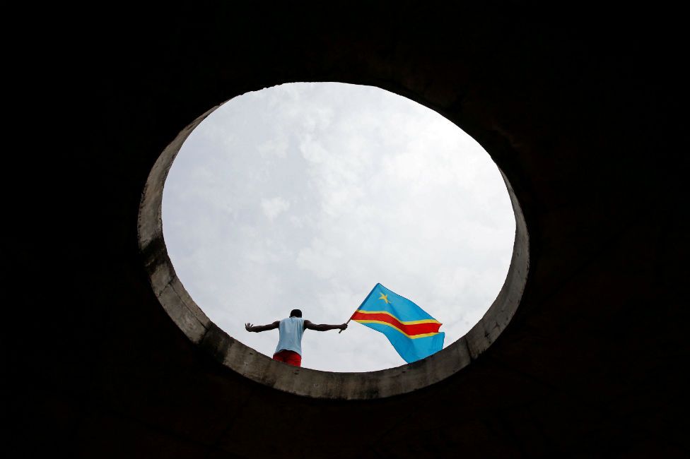 A supporter of Martin Fayulu, runner-up in Democratic Republic of Congo's presidential election holds the Congolese flag during a protest in front of the constitutional court as they wait for him to deliver his appeal contesting Congo's National Independent Electoral Commission (Ceni) results of the presidential election in Kinshasa, Democratic Republic of Congo, January 12, 2019.