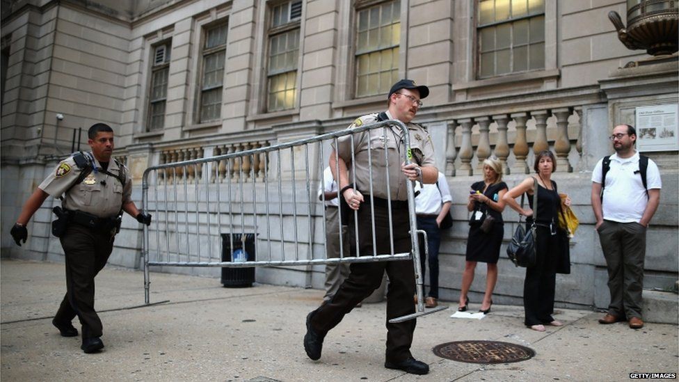 City Sheriff's deputies place barricades in front of the Baltimore City Circuit Courthouse East where pre-trial hearings will be held for six police officers charged in the death of Freddie Gray on 2 September 2015 in Baltimore, Maryland.