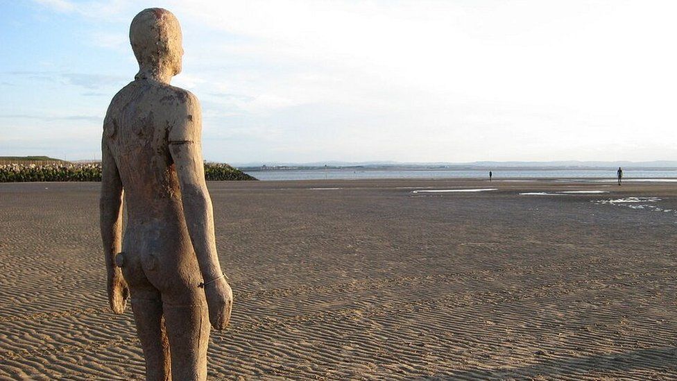 Iron sculpture of a man on Crosby Beach