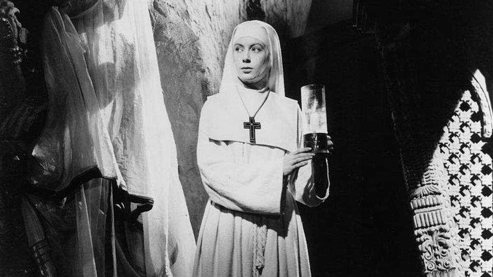Deborah Kerr holds a candle in a scene from the film 'Black Narcissus', 1947. (Photo by Universal Pictures/Getty Images)