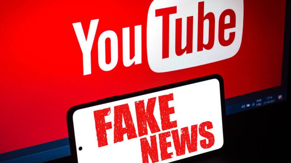 YouTube sign behind a Fake News sign