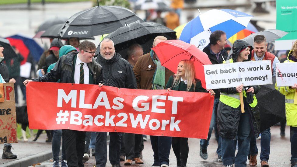 Demonstrators call for the Northern Ireland Assembly to sit again