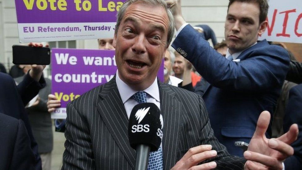 Nigel Farage talks to the media during a Leave event