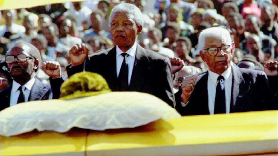 Nelson Mandela salutes the coffin of Chris Hani during his public funeral in 1993