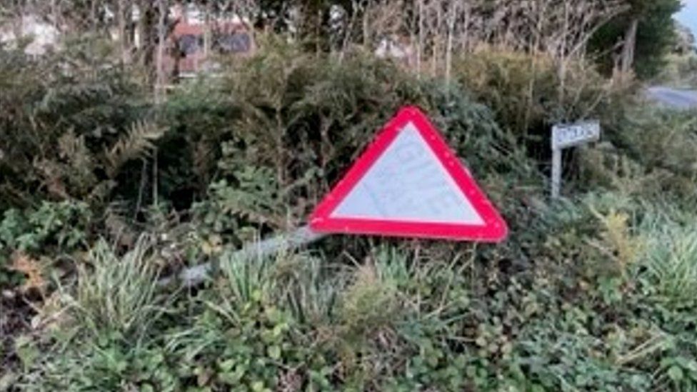 Broken road sign