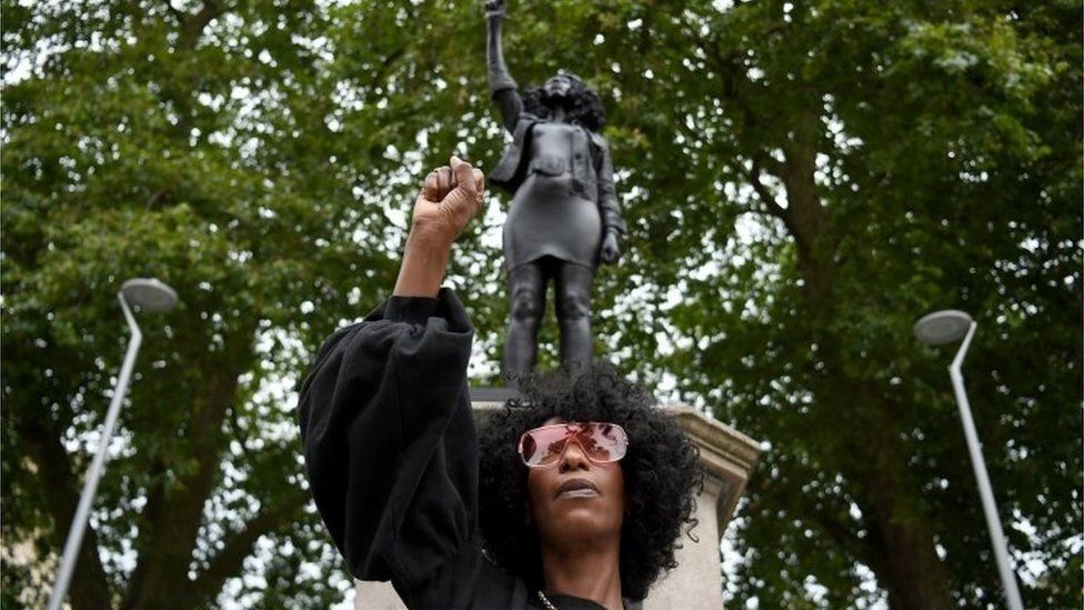 Jen Reid pictured with her statue