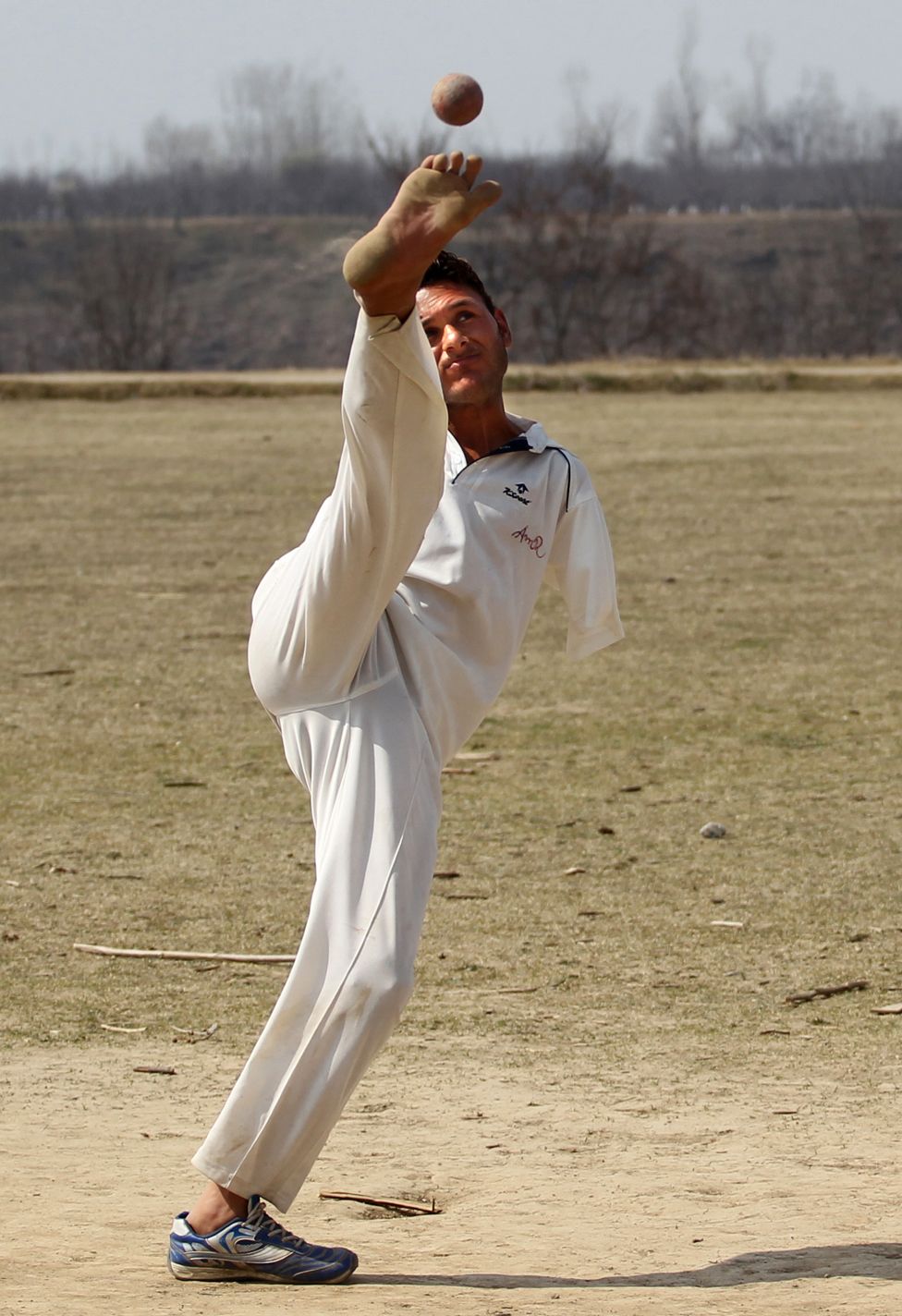 Amir bowls with his foot