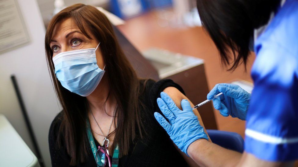 A woman getting her booster vaccine