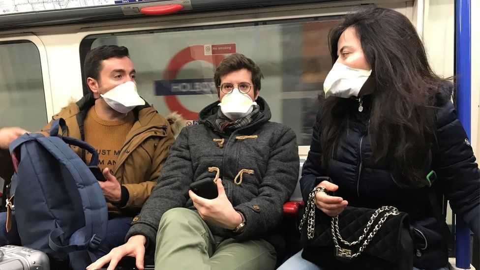 People on a tube wearing face masks