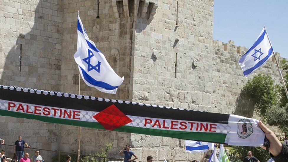 Israel flags and a Palestinian scarf