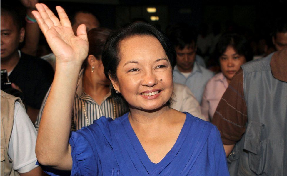 Gloria Macapagal Arroyo waves to supporters after winning a congressional seat on 12 May 2010, as she was leaving the post of president.