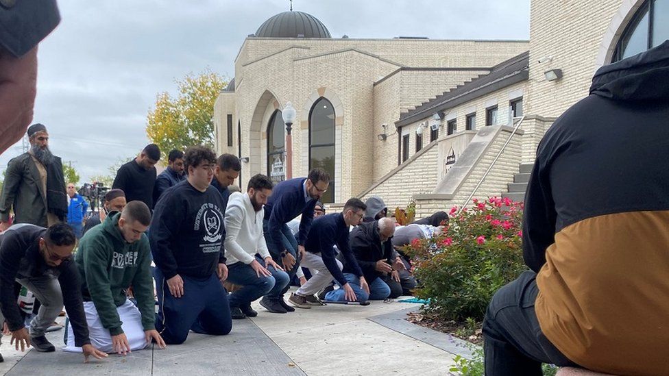 Mourners outside the mosque where the funeral was held