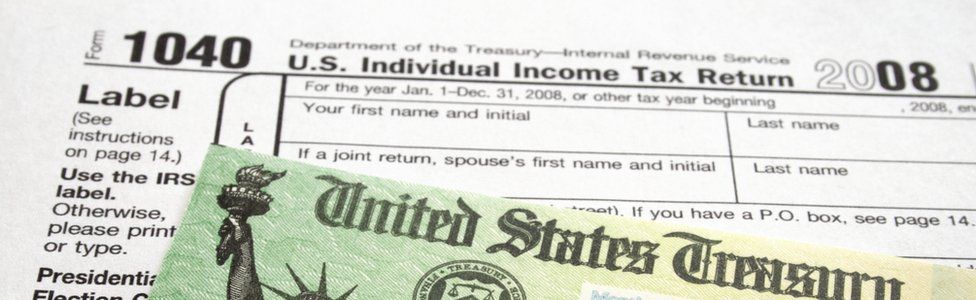 Income Tax Form and Refund Check - Stock image