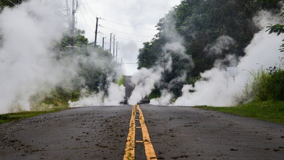 Steam rises from a fissure on a road in Leilani Estates subdivision on Hawaii"s Big Island on May 4, 2018.