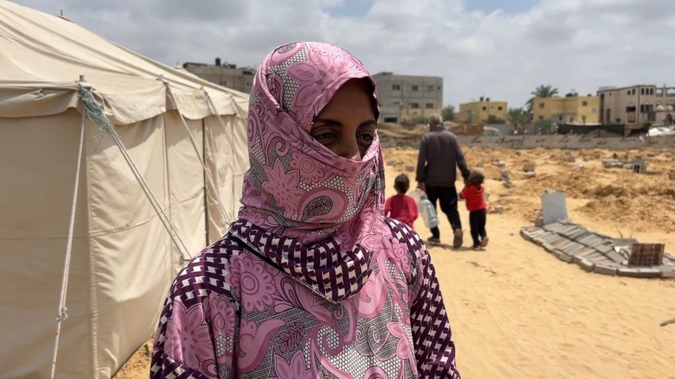 Rehab Abu Daqqa wearing a caput  scarf covering her rima  lasting  successful  beforehand   of a tent