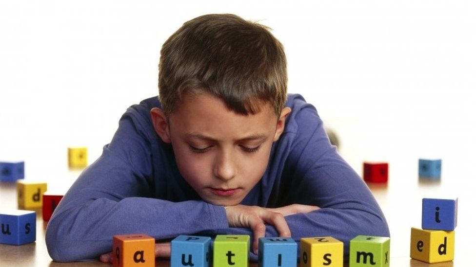 Boy spelling autism