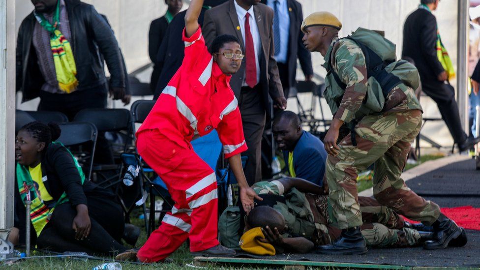 Medics attend to people injured in an explosion during a rally by Zimbabwean President Emmerson Mnangagwa in Bulawayo