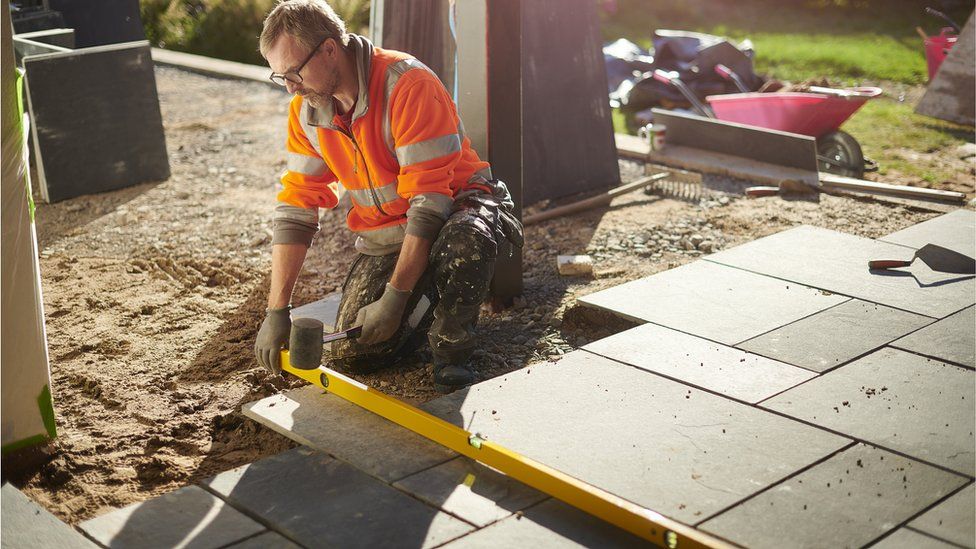 A man laying a patio