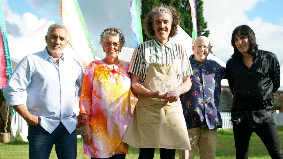 This year's winner Giuseppe (center), along with judges Paul Hollywood and Dame Prue Leith (left), and hosts Matt Lucas and Noel Fielding