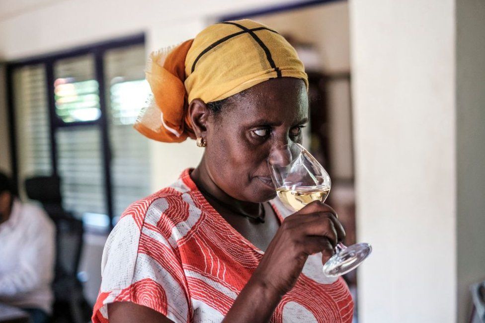 A worker of Awash Wine smells a glass of wine during a wine testing organized for employees in the farm of Awash Wine, in the area of Merti, 120 kilometres from Addis Ababa, Ethiopia, on June 24, 2022