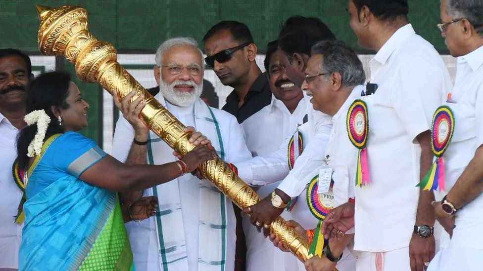 Members of Bharatiya Janata Party (BJP) give a golden scepter to Indian Prime Minister Narendra Modi (C) during a National Democratic Alliance (NDA) rally in Chennai on March 6, 2019.